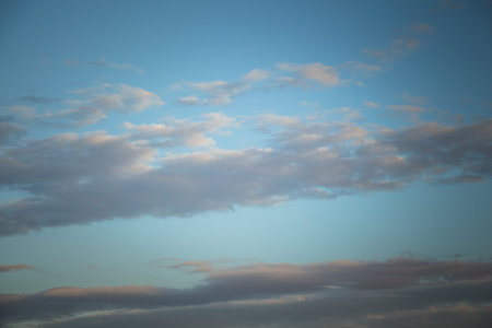 Grey color clouds partly cover the sky in the daytime