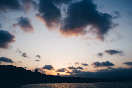 Dramatic colorful  cloudy sky with picturesque clouds lit by sunsetの写真素材