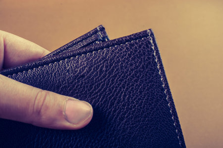Brown leather wallet in hand  saving and finance concept