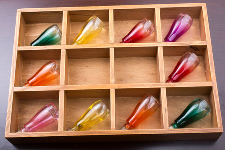 Colorful small bottles in a wooden box in the viewの写真素材