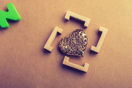 Gold color heart shaped  decorative object in brackets in view