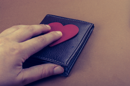 Brown leather wallet in hand  saving and finance conceptの写真素材