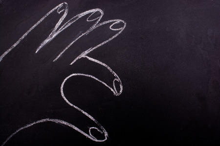 Chalk drawn hand making a half heart in viewの写真素材