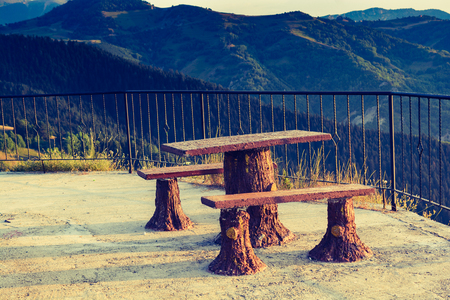 Wooden bench and a desk  in view in natureの写真素材