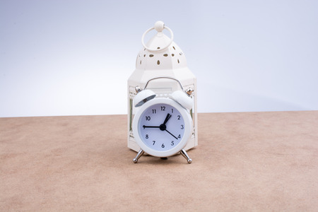 White color alarm clock on brown backgroundの写真素材