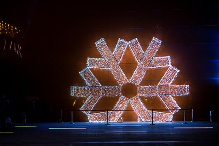 Large white snowflake model on a wall outdoorsのeditorial素材