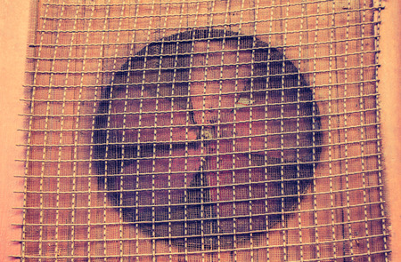 Old rusty red ventilation fan in the viewの写真素材