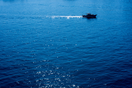 Fishing boat in the waters of the seaの写真素材