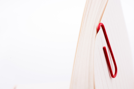 Colored paper clip on a checked notebook  pageの写真素材