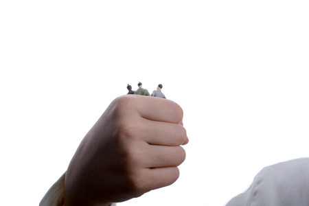 figurine model men in hand on a white backgroundの写真素材