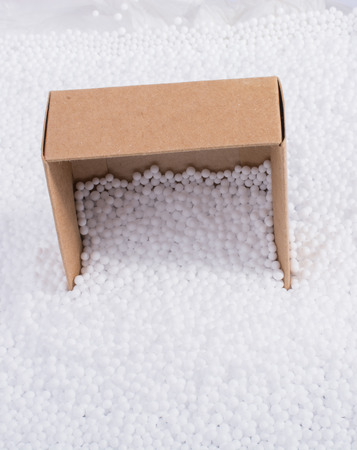 Box on little  white polystyrene foam ballsの写真素材