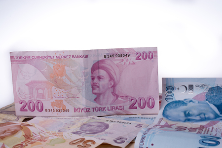 Turkish Lira banknotes of various color, pattern and value on whiteの写真素材