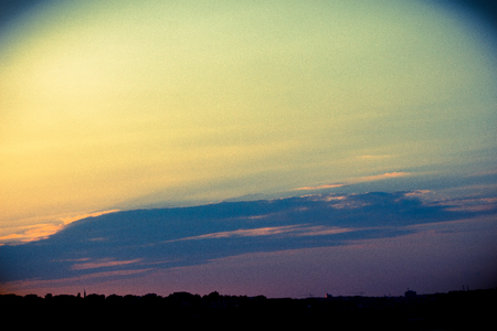 Grey color clouds partly cover the sky in the daytimeの写真素材