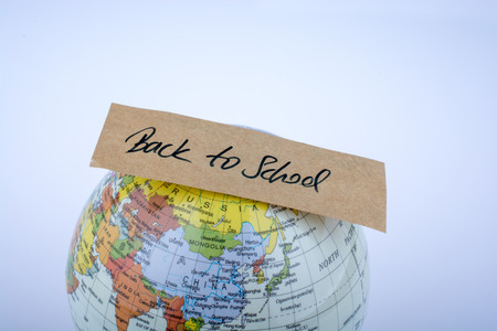Globe and back to school title on a white backgroundの写真素材