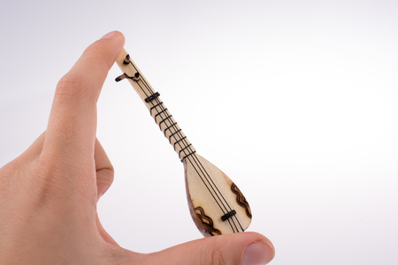 Hand holding the classic turkish instrument Sazの写真素材