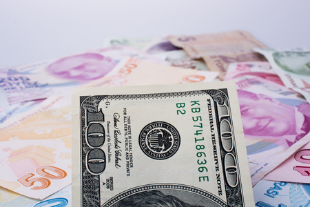American dollar banknotes and Turksh Lira banknotes side by side on white backgroundの写真素材