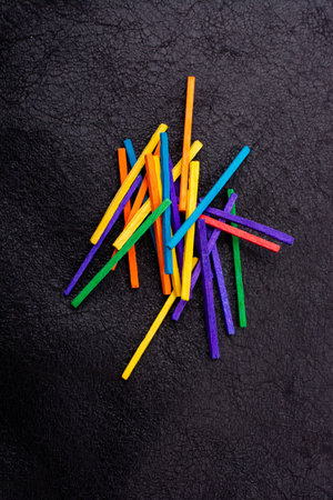 Beautiful coloured wooden  sticks for creativity on black background