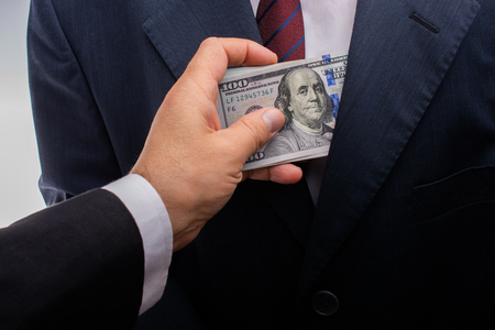 Concept for corruption and bribing fraud finance with Bundle of dollarの写真素材