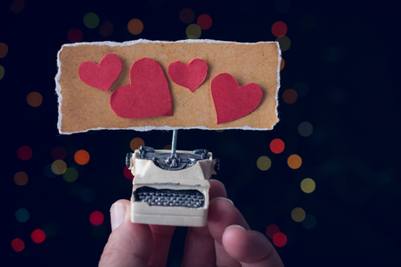 Valentine's day wording on torn  typewriter as Love conceptの写真素材