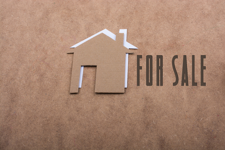 Little paper houses on a brown backgroundの写真素材