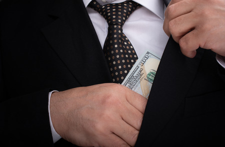 Businessman holding US dollar banknote money on white backgroundの写真素材