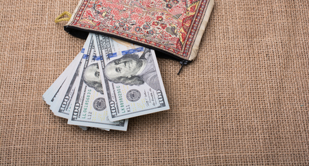Banknote of US dollar in a purse on a linen canvasの写真素材