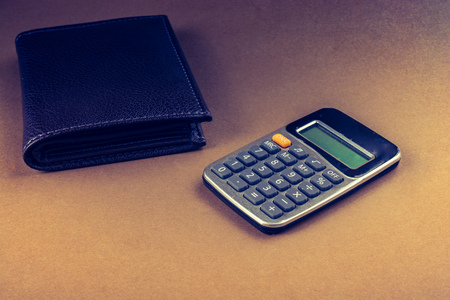 Calculator and wallet as  saving and finance conceptの写真素材