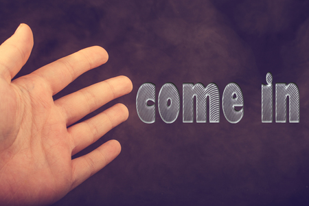 Hand making welcome gesture  saying come inの写真素材