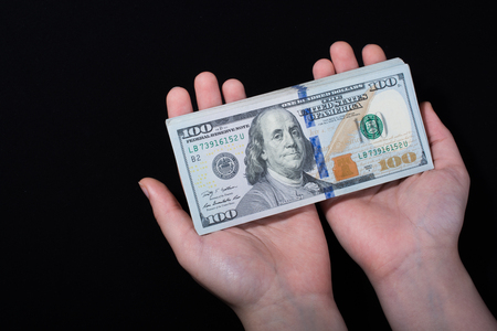 Hand holding American dollar  banknotes isolated on white backgroundの写真素材