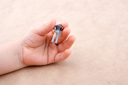 Little man figure in hand  on a white backgroundの写真素材