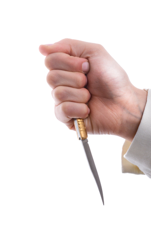 Hand holding a knife in hand on a white backgroundの写真素材