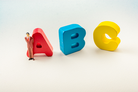 Man figurine and Letters of abc of alphabet on whiteの写真素材