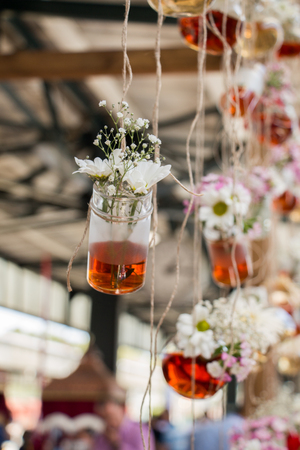 Herbal tea bottles with flowers hanging on stringsの写真素材