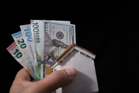 Hand holding American dollar  banknotes isolated on black backgroundの写真素材