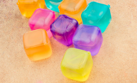 Fake colorful ice cubes on a brownの写真素材