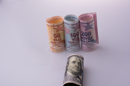 American dollar banknotes and Turksh Lira banknotes side by side on whiteの写真素材