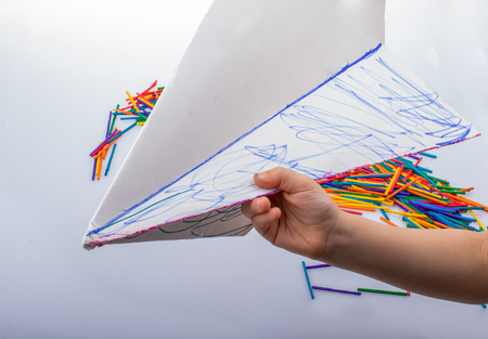 Hand holding paper plane in hand as creative conceptの写真素材