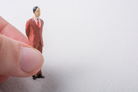Tiny figurine of man miniature model in handの写真素材