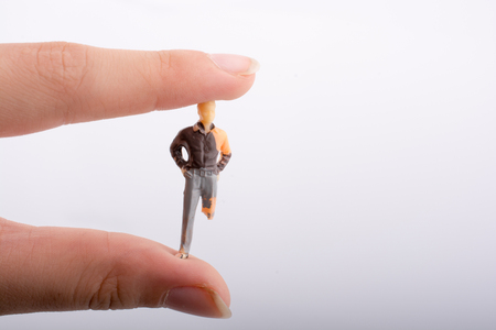 Little man figure with a crippled leg in hand  on a white backgroundの写真素材
