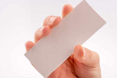 Hand holding a note paper on a white backgroundの写真素材