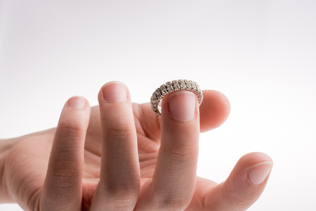 Hand wearing a ring on a white backgroundの写真素材