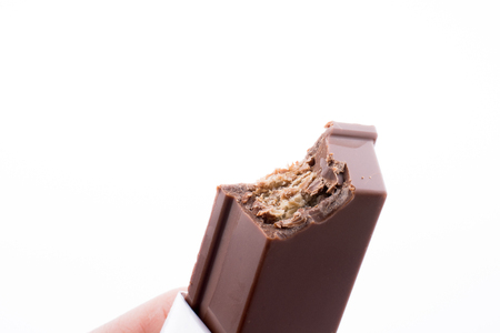 Bitten Chocolate bar on a white backgroundの写真素材