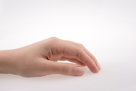 Human hand pointing on a white backgroundの写真素材