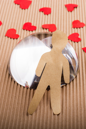 Man shape cut out of paper on paper backgroundの写真素材