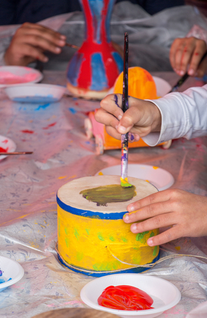 Young children decorating handmade drumの写真素材