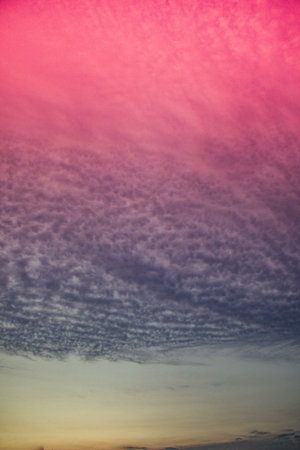 Grey color clouds partly cover the sky in the daytime