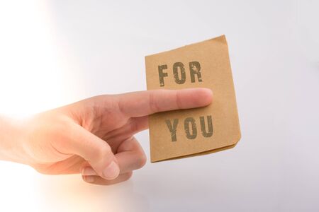 Hand holding paper paper with  For you textの写真素材