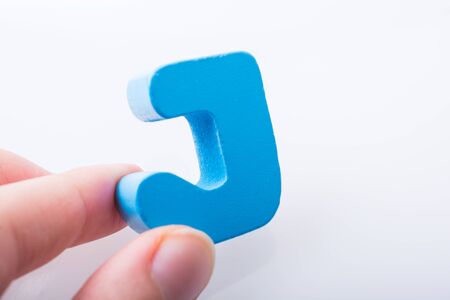 Hand holding Letter cube  J of  Alphabetの写真素材