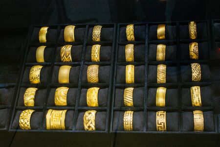 Shop display of dozens of golden bracelets and banglesの写真素材
