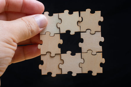 man holding last piece of jigsaw puzzle as business strategy concept